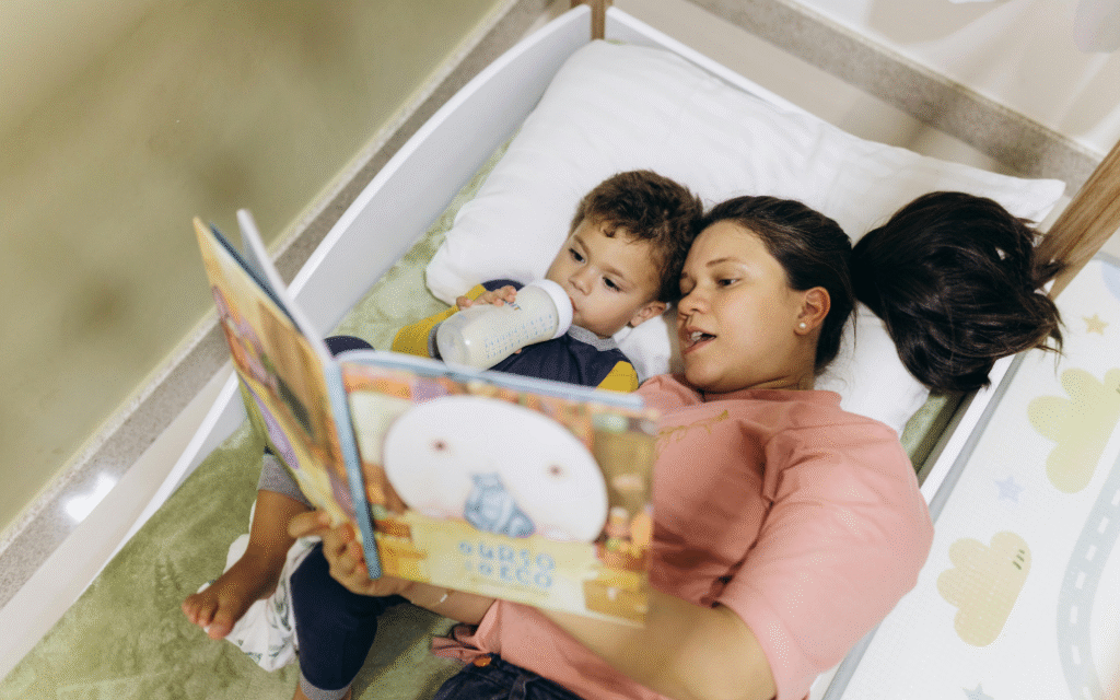 A mother is reading a book with her child and explaining the meaning of the book to her child.